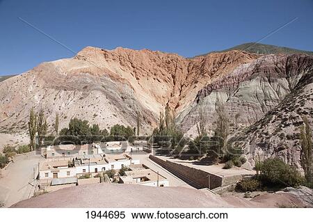 Stock Photography - Purmamarca and the Upper Cretaceous Yacoraite Formation of Cerro de los Siete Colores (Hill of the Seven Colors), Jujuy, Argentina. Fotosearch