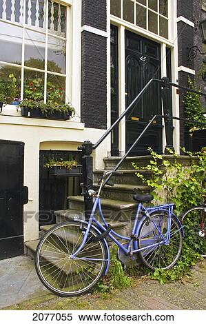 Stock Photography - Purple Bike Outside A House On Brouwersgracht; Amsterdam Netherlands. Fotosearch