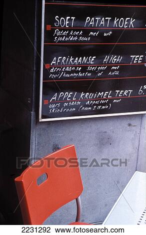 Stock Image - Pygma-Lion, South Afrikaan Restaurant, Outside Board And Chair, Nieuwe Spiegelstraat 5A, Amsterdam, Netherlands.. Fotosearch