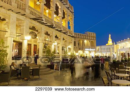 Stock Photo - Qatar, People walking through Wafi souk at dusk; Doha. Fotosearch