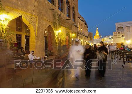 Stock Photograph - Qatar, People walking through Wafi souk at dusk; Doha. Fotosearch