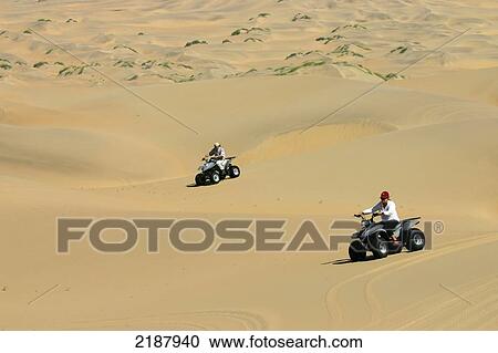 Stock Image - Quad biking in the Koakoland Desert; Namibia. Fotosearch