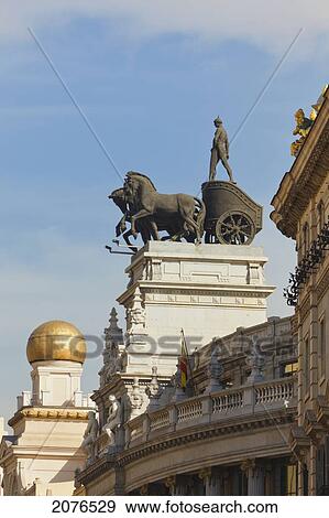 Quadriga On Roof Of Banco De Bilbao Building Four Horses Drawing A Two Wheeled Chariot; Madrid Spain View Large Photo Image Stock Photo - Quadriga On Roof Of Banco De Bilbao Building Four Horses Drawing A Two Wheeled Chariot; Madrid Spain. Fotosearch