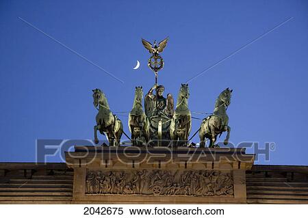 Stock Photography - Quadriga, The Four-Horsed Chariot Atop The Brandenburg Gate At Night, Berlin, Germany. Fotosearch