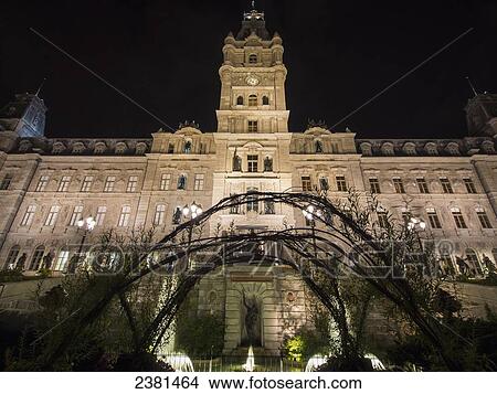 Picture - Quebec City's parliament building with water fountains illuminated at nighttime; Quebec City, Quebec, Canada. Fotosearch