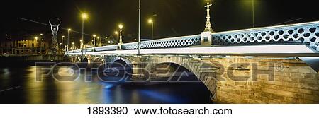 Stock Image - Queens Bridge Over River Lagan At Night. Fotosearch