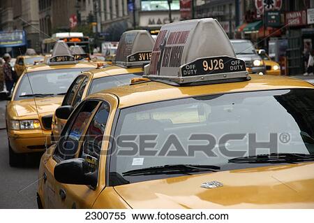 Queue of yellow taxis outside Penn Station, Midtown Manhattan; New York City, New York, United States of America View Large Photo Image Stock Photography - Queue of yellow taxis outside Penn Station, Midtown Manhattan; New York City, New York, United States of America. Fotosearch