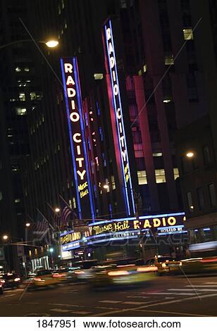 Stock Image - Radio City Music Hall, Manhattan, New York City, Usa; Traffic Going By Theatre At Night. Fotosearch