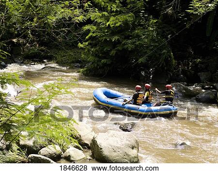 Stock Photo - Rafters In Inflatable Raft On Rapid River. Fotosearch