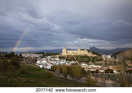 Stock Image - Rainbow In The Sky Over The Old Moorish Castle; Antequera Andalusia Spain. Fotosearch