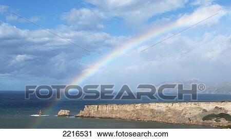 Stock Image - Rainbow On Triopetra Beach, Matalan, Crete, Greece. Fotosearch