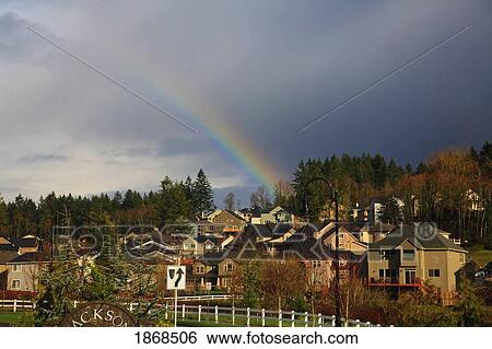 Stock Photograph - Rainbow Over A Residential Area. Fotosearch