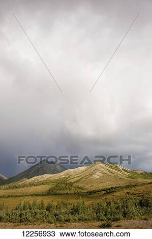 Rainbow over mountains with rainclouds in the background, Interior Alaska View Large Photo Image Stock Image - Rainbow over mountains with rainclouds in the background, Interior Alaska. Fotosearch