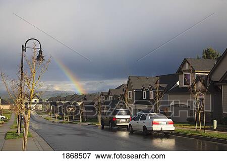 Stock Photo - Rainbow Over Residential Area After The Rain. Fotosearch