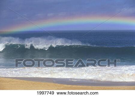 Stock Photo - Rainbow Over Shore Break Beach Foreground, Horizon And Blue Sky With Clouds A21E. Fotosearch