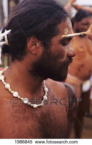 Stock Photography - Rapa Nui Culture; Easter Island, Local man having paint applied to Face, Tapati Festival. Fotosearch