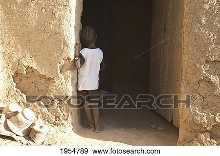 Rear view of a boy standing against wall in Djenne, Mali View Large Photo Image Stock Photo - Rear view of a boy standing against wall in Djenne, Mali. Fotosearch
