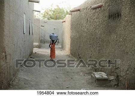 Rear view of a woman walking on street in Djenne, Mali View Large Photo Image Picture - Rear view of a woman walking on street in Djenne, Mali. Fotosearch
