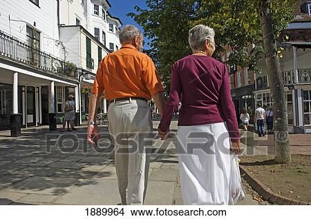 Picture - Rear View Of Elderly Couple Walking Down The Pantiles.. Fotosearch