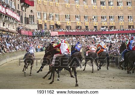 Stock Image - Rear view of Palio horse race around the central Campo. Palazzio Campo. Palio, Siena, Tuscany, Italy., Palio, Siena, Tuscany, Italy.. Fotosearch