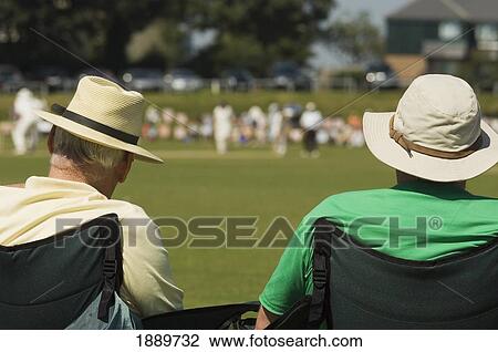 Rear View Of Spectators Watching A Cricket Match On A Hot Summers Day At Hastings. View Large Photo Image Stock Image - Rear View Of Spectators Watching A Cricket Match On A Hot Summers Day At Hastings.. Fotosearch