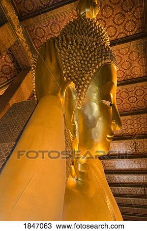 Stock Image - Reclining Buddha At Wat Pho Temple In Rattanakosin District; Bangkok, Thailand. Fotosearch
