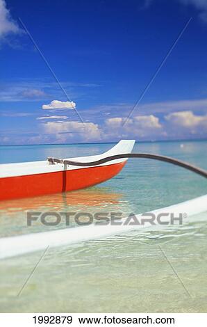 Red And White Outrigger Canoe Floating On Calm Turquoise Water. View Large Photo Image Stock Photo - Red And White Outrigger Canoe Floating On Calm Turquoise Water.. Fotosearch