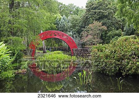 Red arched bridge crossing tranquil water in park; Mobile, Alabama, USA View Large Photo Image Stock Photograph - Red arched bridge crossing tranquil water in park; Mobile, Alabama, USA. Fotosearch