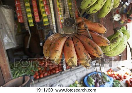 Stock Image - Red Bananas Hanging Up For Sale In Tanzania. Fotosearch