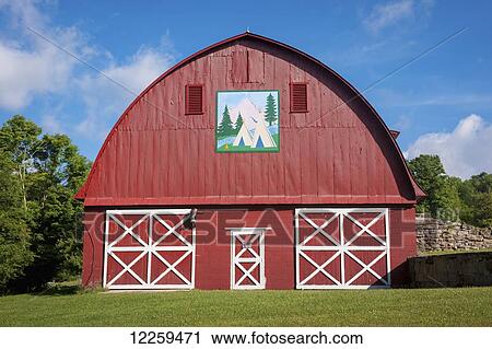 Stock Image - Red barn with vintage American Indian painting in Garrett County; Maryland, United States of America. Fotosearch