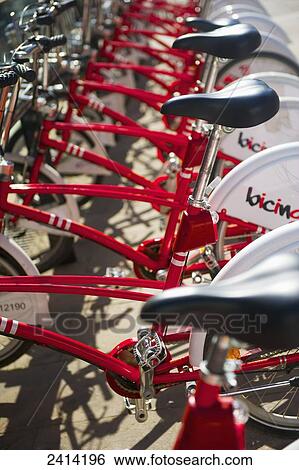 Red bicycles for rent parked in a row; Barcelona, Spain View Large Photo Image Stock Photograph - Red bicycles for rent parked in a row; Barcelona, Spain. Fotosearch