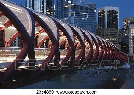 Stock Image - Red Bridge At Night With Lights And City Buildings In The Background; Calgary, Alberta, Canada. Fotosearch