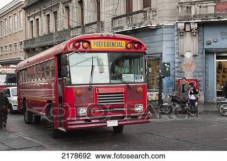 Stock Image - Red Bus In The Street; Guatemala City Guatemala. Fotosearch