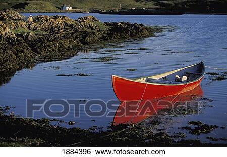 Stock Photograph - Red Canoe Moored Off Coast. Fotosearch