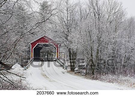 Stock Image - Red Covered Bridge In The Winter; Adamsville Quebec Canada. Fotosearch