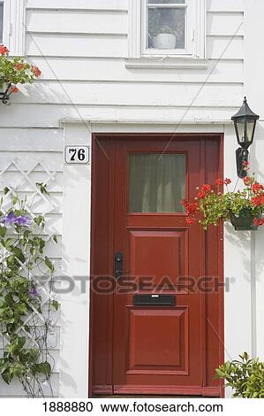Red Door Of A Traditional Wooden House With Geraniums And Clematis Plants View Large Photo Image Stock Image - Red Door Of A Traditional Wooden House With Geraniums And Clematis Plants. Fotosearch