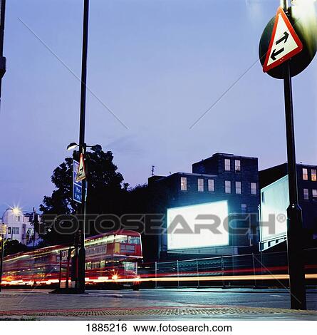 Red Double-Decker Buses On Street In Front Of Billboard, Blurred Motion View Large Photo Image Stock Photograph - Red Double-Decker Buses On Street In Front Of Billboard, Blurred Motion. Fotosearch