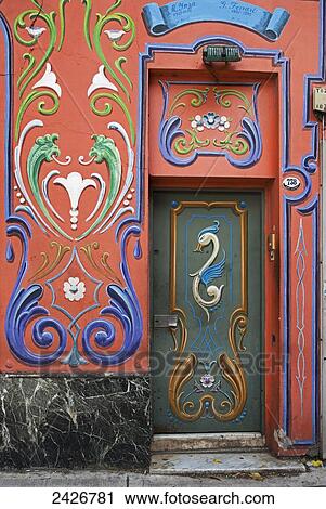 Stock Image - Red house facade painted with colourful design and decorated with filete; Buenos Aires, Argentina. Fotosearch