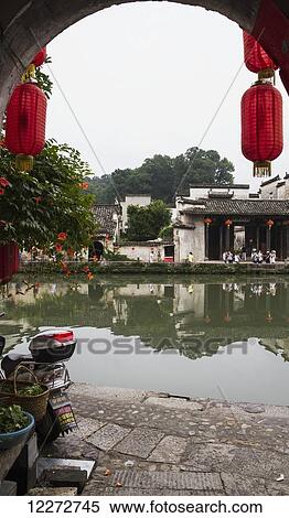 Stock Photography - Red lanterns on a house by the Moon Pond, Hongcun, Anhui, China. Fotosearch