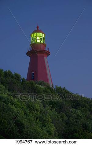Stock Photo - Red Lighthouse Illuminated; La Martre Quebec Canada. Fotosearch