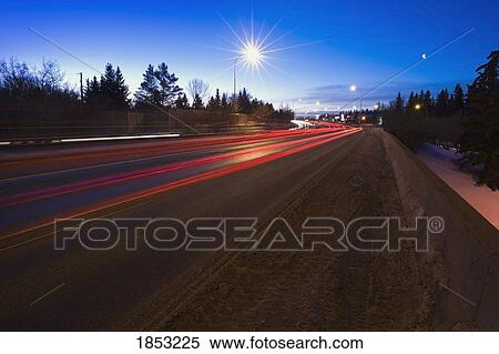 Stock Photography - Red Tail Lights At Twilight, St. Albert, Alberta, Canada. Fotosearch