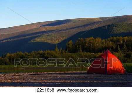 Red tent on the river shore; Dawson, Yukon, Canada View Large Photo Image Stock Photo - Red tent on the river shore; Dawson, Yukon, Canada. Fotosearch