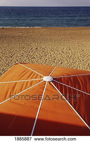 Stock Photo - Red Umbrella On Beach, Close Up. Fotosearch