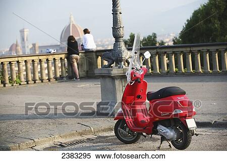 Red vespa scooter parked up by couple at square Piazzale Michelangelo overlooking Firenze/ Florence city with Duomo cathedral; Tuscany, Italy View Large Photo Image Stock Photography - Red vespa scooter parked up by couple at square Piazzale Michelangelo overlooking Firenze/ Florence city with Duomo cathedral; Tuscany, Italy. Fotosearch