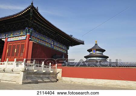 Red Walls Of A Building In Traditional Chinese Architecture And A Pagoda In The Background Against A Blue Sky; Beijing China View Large Photo Image Picture - Red Walls Of A Building In Traditional Chinese Architecture And A Pagoda In The Background Against A Blue Sky; Beijing China. Fotosearch