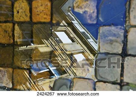 Reflection in glass of a residential building and pavers on a walkway, Marais district; Paris, France View Large Photo Image Stock Photo - Reflection in glass of a residential building and pavers on a walkway, Marais district; Paris, France. Fotosearch