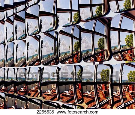 Stock Photography - Reflection of lounge chairs on the coast in mirrors in a row, Miami Beach; South Beach, Florida, United States of America. Fotosearch