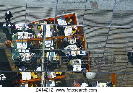 Reflection of restaurant outdoor patio seating in the mirrored wall of a building; Barcelona, Spain View Large Photo Image Stock Image - Reflection of restaurant outdoor patio seating in the mirrored wall of a building; Barcelona, Spain. Fotosearch