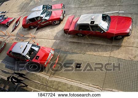 Reflection Of Taxis; Hong Kong, Hong Kong Island, China View Large Photo Image Picture - Reflection Of Taxis; Hong Kong, Hong Kong Island, China. Fotosearch