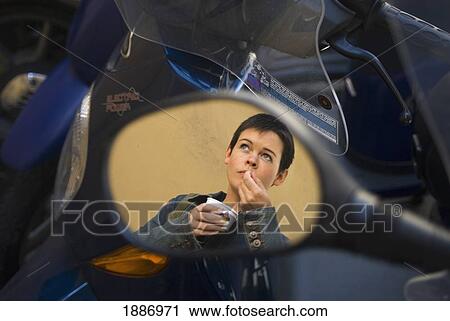 Reflection Of Woman Eating Ice Cream In Scooter Mirror View Large Photo Image Stock Image - Reflection Of Woman Eating Ice Cream In Scooter Mirror. Fotosearch